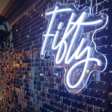 Fifty neon sign on a black shimmer wall for Shane's 50th birthday in Wellington Point.