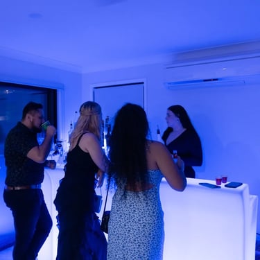 Guests at Carly and Kahn's vow renewal being served at the glow bar in Redland Bay.