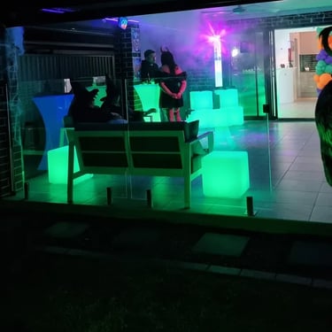 Guests chilling at the Halloween event with glow cubes and cocktail towers, Redland Bay.