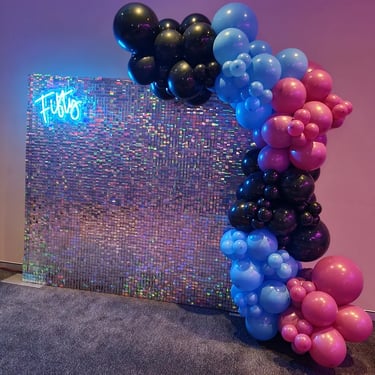 Irididescent shimmer wall and fifty neon with balloons for Mary's 50th birthday in Redlands.