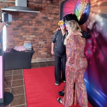 Chrissy and her friends in the disco themed photo booth for her MS fundraiser in Capalaba.