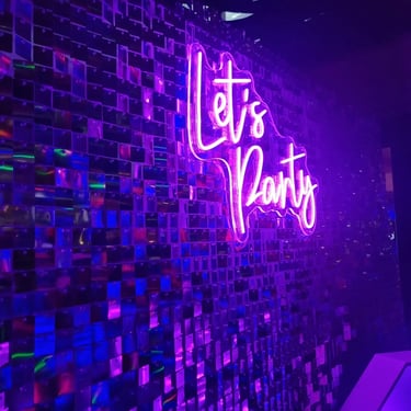 Neon Sign glowing with Let’s Party for a 60th Birthday in Currumbin, Gold Coast - party hire by SweetAz Co.