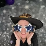 Carly from SweetAz Co. posing in the photo booth for a 60th birthday event in Brisbane.
