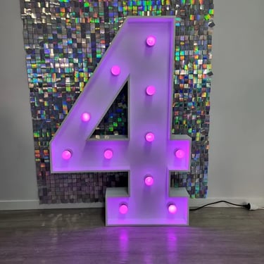 Pink four marquee number in front of an iridescent shimmer wall in Coomera.