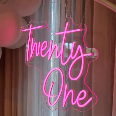 Pink twenty one neon handing on the circle hoop backdrop at event in Cleveland.