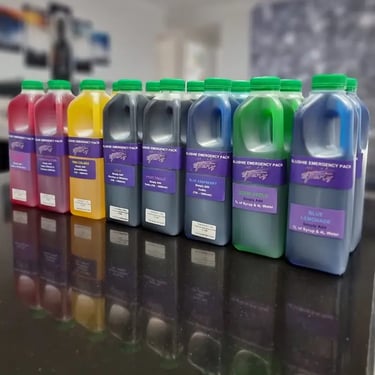 Slushie machine emergency syrup flavours on the bench in a rainbow of colours in Redland Bay.