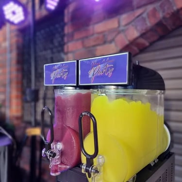 Red and yellow slushie frozen and ready in the slushie machine at event in Capalaba.