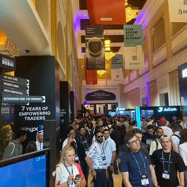 A photograph of the Token2049 Dubai event, many people and stalls in motion.