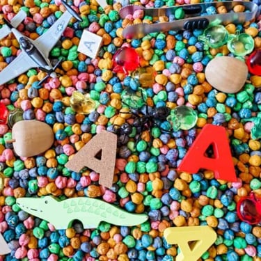 sensory box with toys and letters