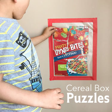 boy playing with a cereal box puzzle