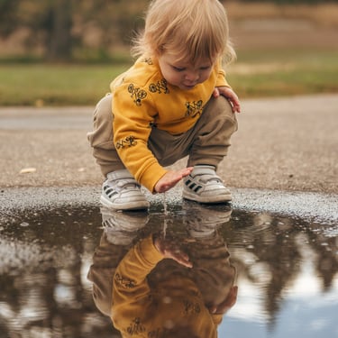 little boy playing in a paddle