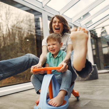 mom  and boy playing in a little car