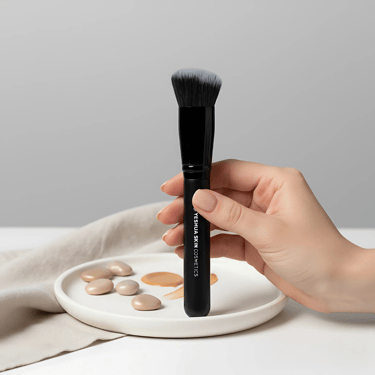 a person holding a foundation brush
