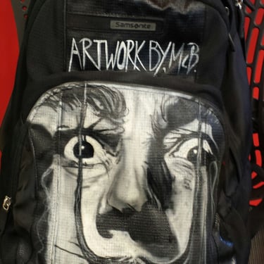 Freehand airbrush painting on a backpack