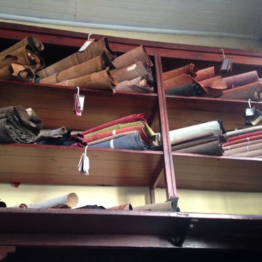 image of rolls of deadstock leather on shelves