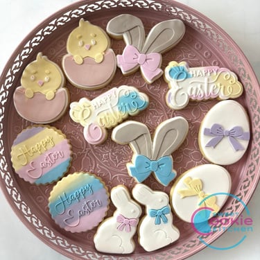 A plate of Easter fondant cookies, bunnies, chicks and eggs.