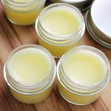 ngredients for DIY papaya lip balm recipe on wooden surface