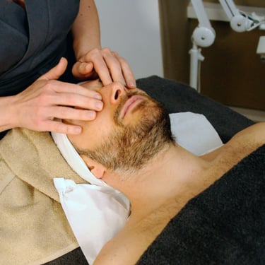 person gently massaging another person's face