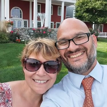 a man and woman are smiling and posing for a picture