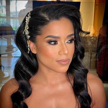 Bride with soft waves, glamorous smoky eye makeup, and a jeweled hairpiece for an elegant wedding look