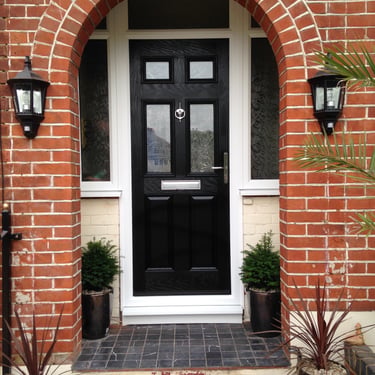 a black front door 2 panel 2 square glass with side panels