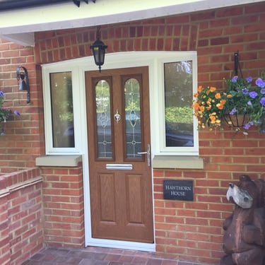 oak wood colour composite door with decorative glass and half glazed side panels 