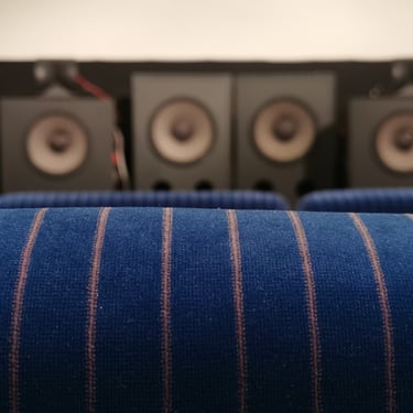 Hypnos Theatre's vintage cinema chairs and JBL speaker array.