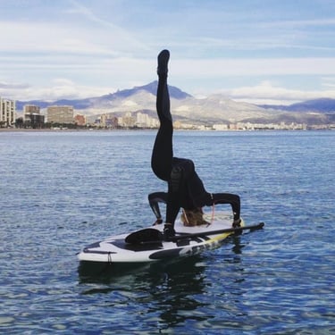 Stand Up Paddle Yoga position girl in wetsuit