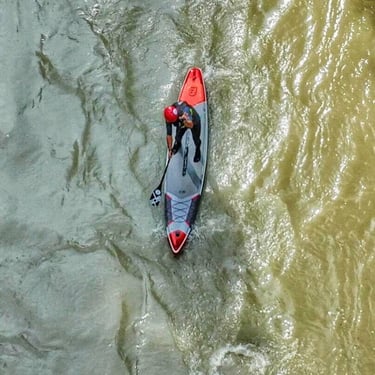Girl on Stan Up Paddle drone view of river