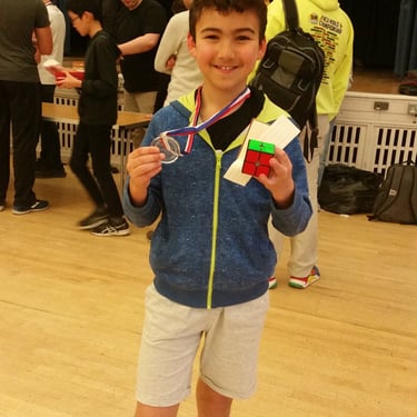 James Alonso holding up his first medal at a competition