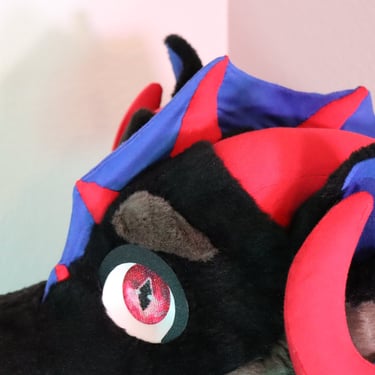 A dragon head made by Teto Creations featuring large curly horns, expressive moving eyelids and silicone teeth