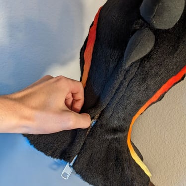 A incorporator fursuit Dino mask made by Teto Creations Featuriong a line of horns, 3d printed eyes and a painted gradient