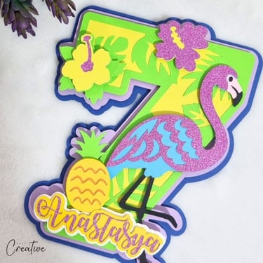 Cake topper in the shape of number 7. Tropical vibe with flamingo.