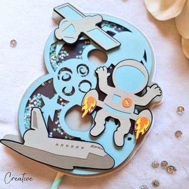 Cake topper in a shape of number 8. Space and astronaut theme.