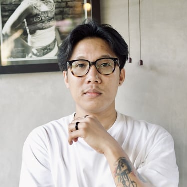 a man with tattoos on his arm and a tattoo on his arm