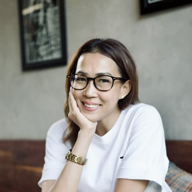 a woman in glasses and a white shirt