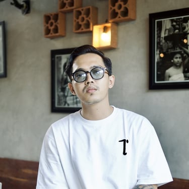 a man with glasses and a white shirt