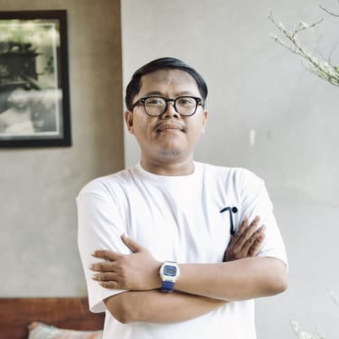 a man with glasses and a watch on his arm