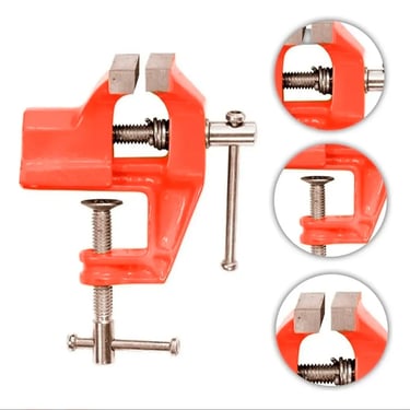 Red metal bench vise tool with clamp base and adjustable jaws for woodworking and jewelry tasks.