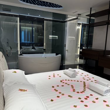 a bed with a large bed and a bathtub
