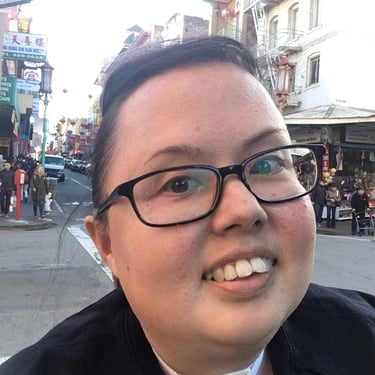 Selfie of Stacey in Chinatown with a huge smile.