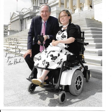 Photo of Senator Harkin and Stacey in front of Congress, there is a handwritten note on it from the senator.