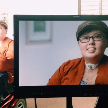 Photo of behind the scene shot of Stacey being interviewed. Stacey is shown in the view finder and in the background.