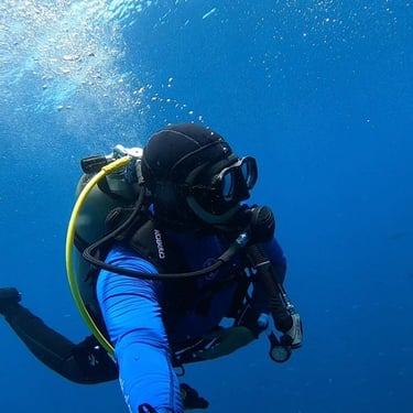a person in a scuba suit is holding a scuba suit
