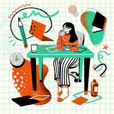 a woman sitting at a desk with a laptop and a notebook