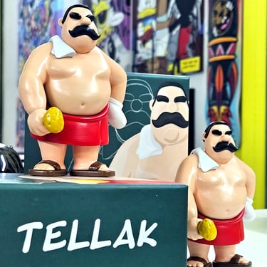 Tellak vinyl toy figure with mustache, red towel, and bath accessories on display box.