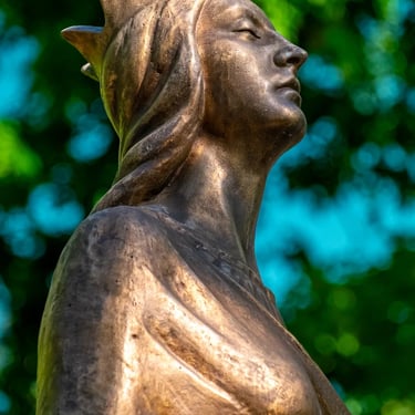 Upper body of Saint Barbara viewed from the side, highlighting her serene expression and traditional attire.