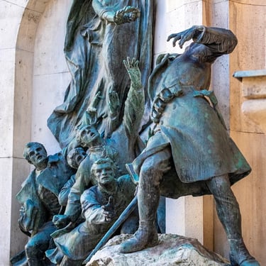 Side angle of the memorial, highlighting the soldier and the group of students rushing forward.