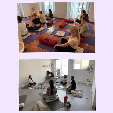 A group of yoga students during a workshop, sitting down in easy pose.