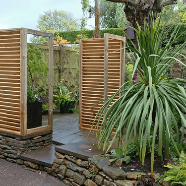 a photo of a patio garden screened off with fencing and plants